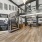 a large room with a wood floor and a wood staircase