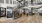 a large room with a wood floor and a wood staircase