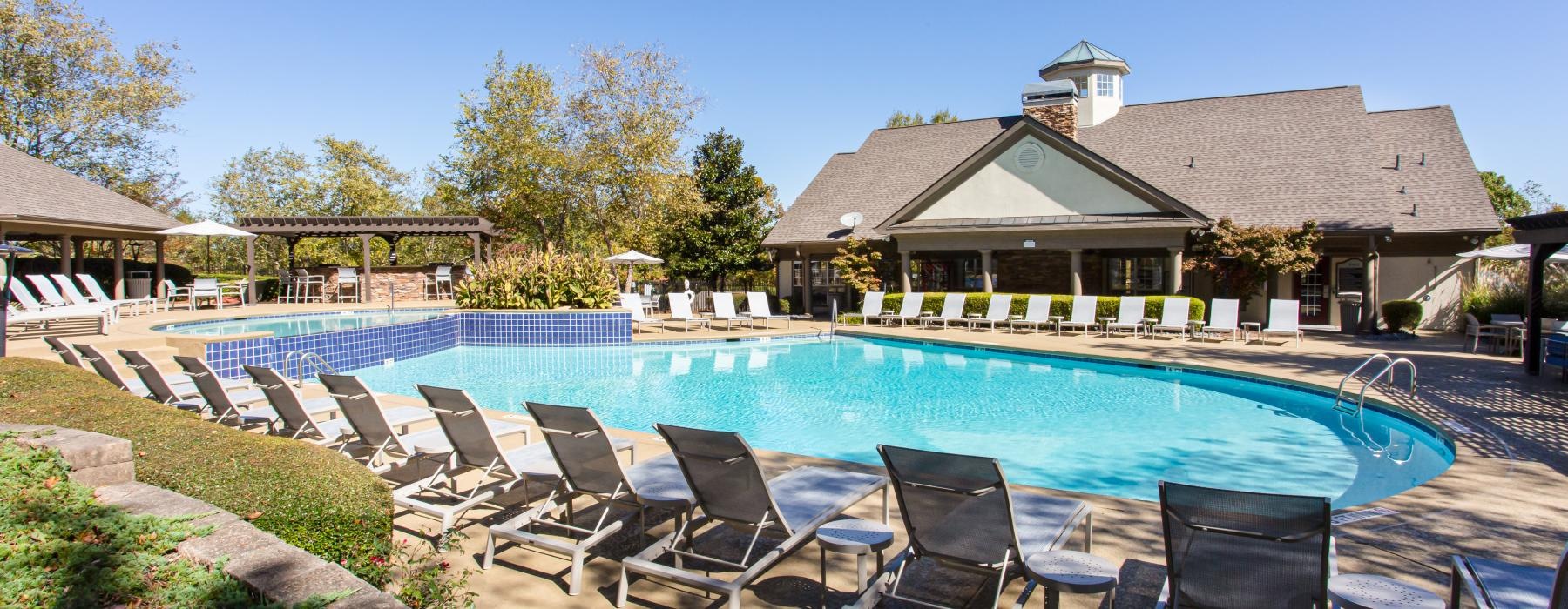 a swimming pool with chairs around it