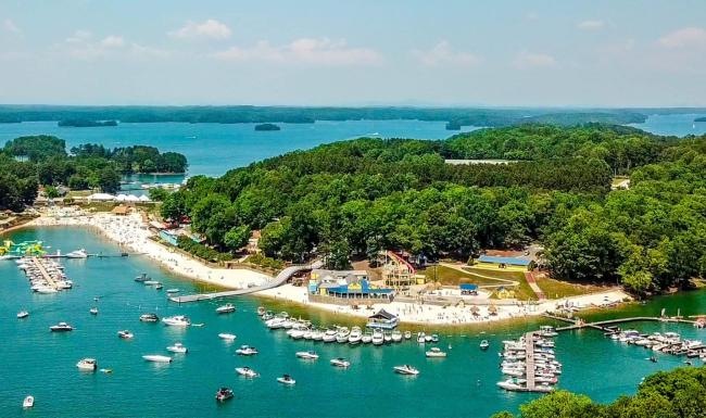 A beautiful community at the heart of all your passions a body of water with boats and trees around it